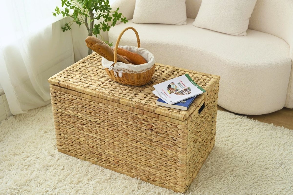 Wicker trunk coffee table styled with a bread basket and magazines for casual daily use.