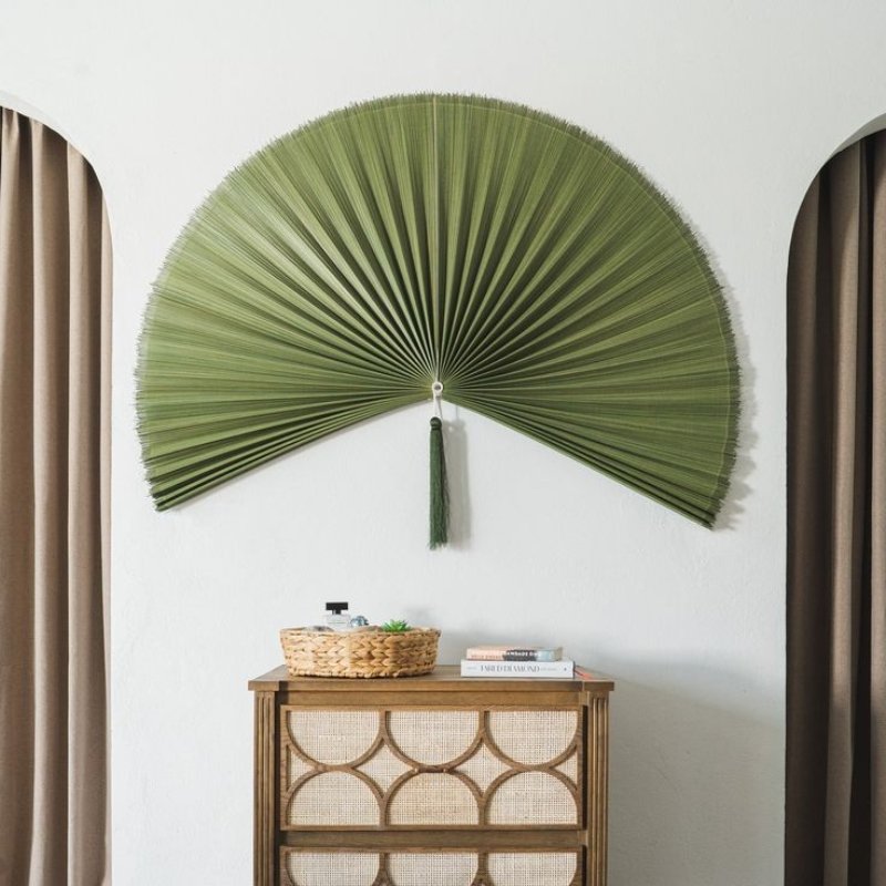 Green bamboo fan wall art behind mid century sideboard Green bamboo fan wall art behind mid century sideboard