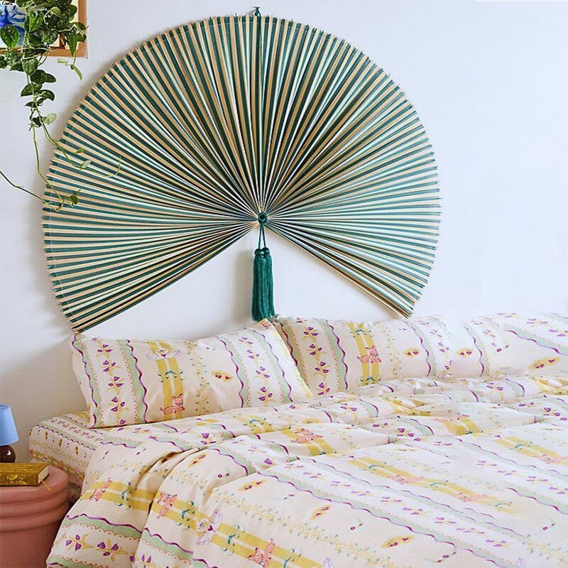 Green large bamboo fan wall decor above bed Green large bamboo fan wall decor above bed