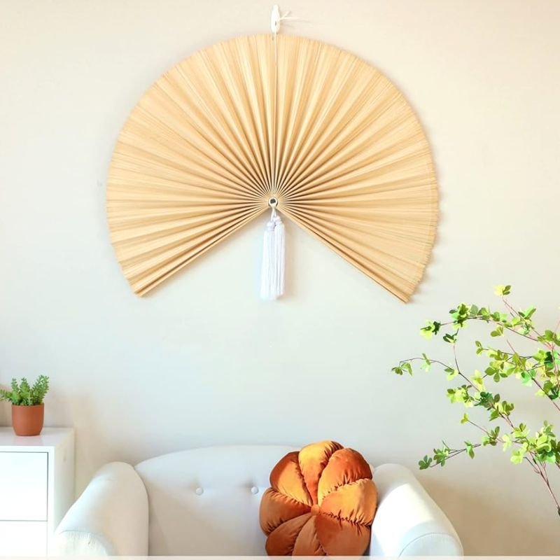 Large bamboo wall fan above cozy white chair Large bamboo wall fan above cozy white chair