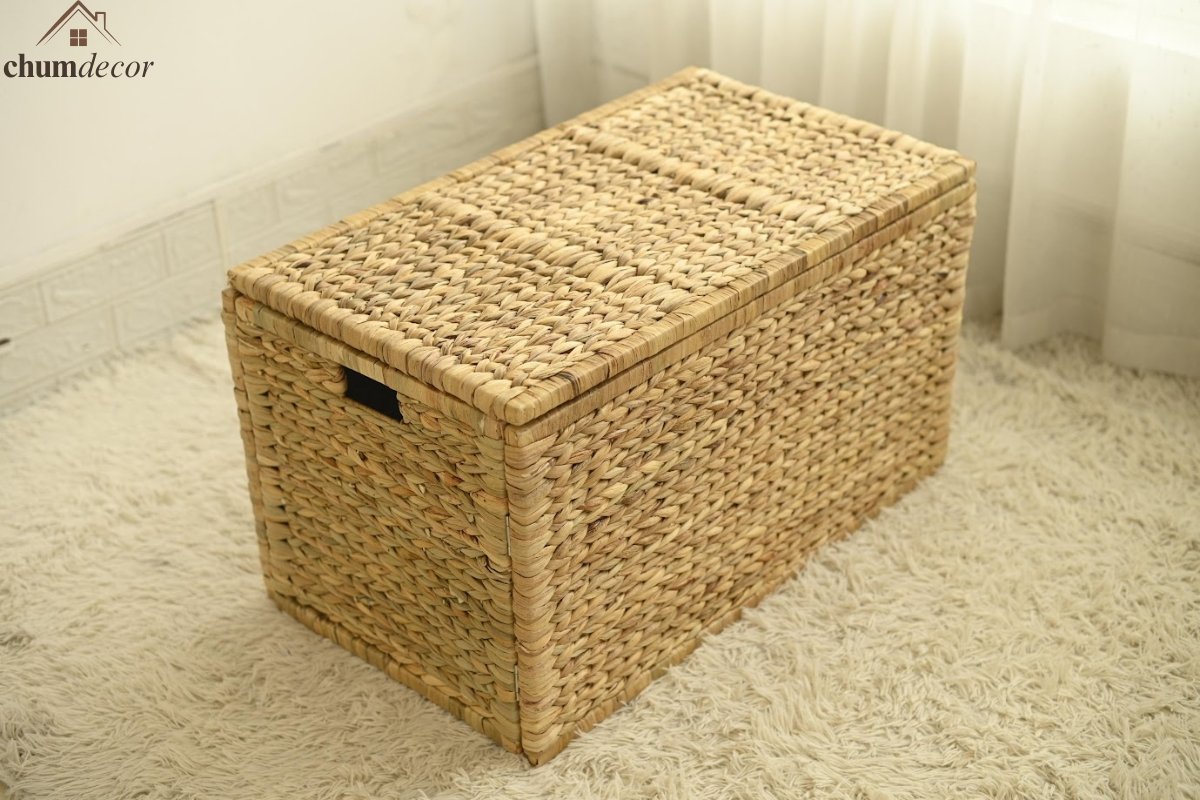 Minimalist Wicker Storage Trunk in a Bright Neutral Room Minimalist wicker storage trunk fully closed, styled in a bright neutral corner with sheer curtains.