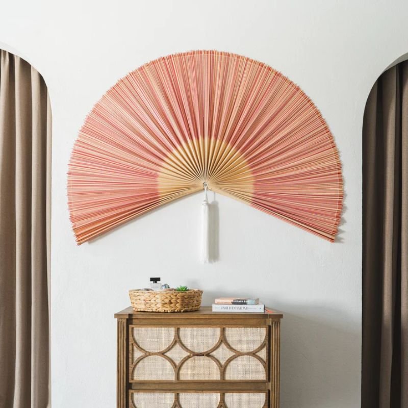 Red pink large decorative fan for wall near neutral textures Red pink large decorative fan for wall near neutral textures