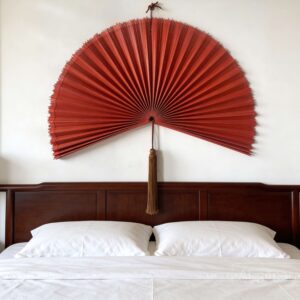 Large bamboo wall fan decor above bed in modern bedroom interior
