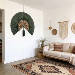 Large handmade dark green bamboo wall fan displayed above bed in boho bedroom interior